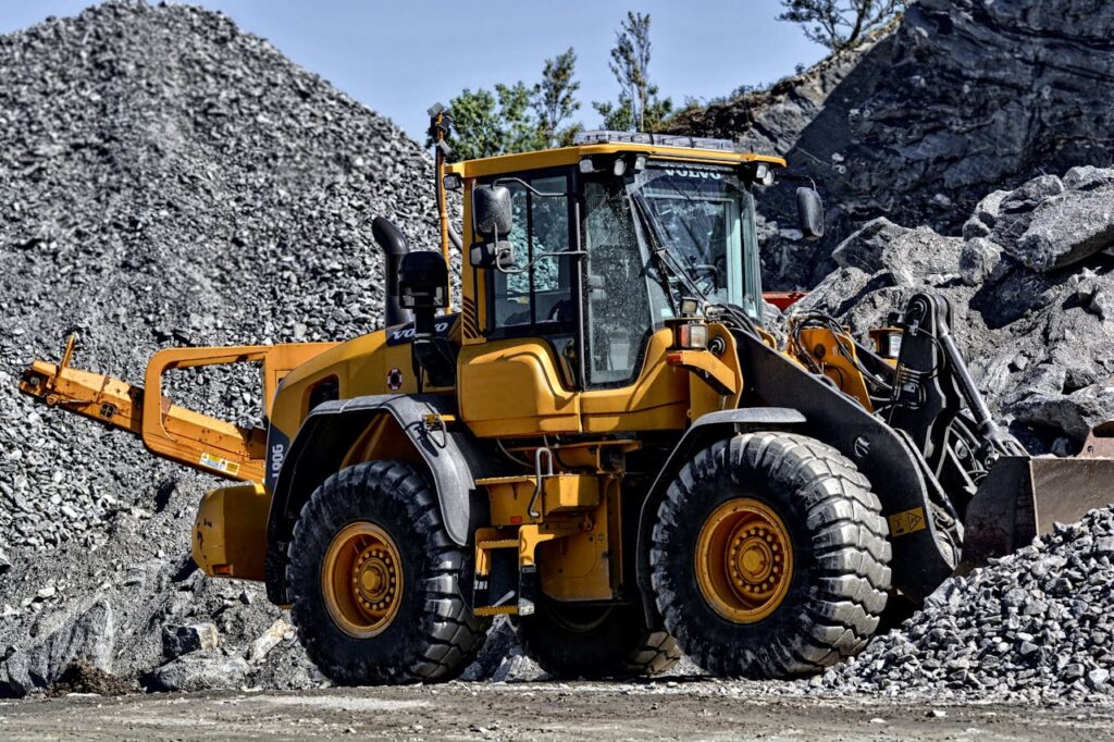 orange-and-black-tractor-next-to-piles-of-rocks-162639 Orange and Black Tractor Next to Piles of Rocks